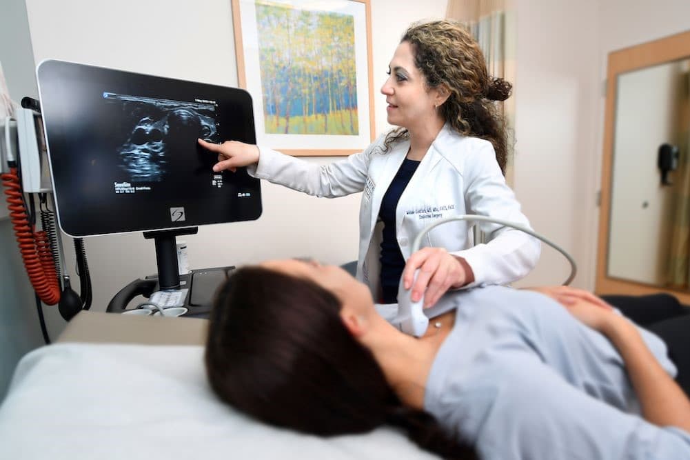 Thyroid ultrasound being performed on patient